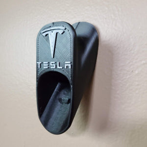 Tesla charging cord organizer hanger for mobile charger cable.